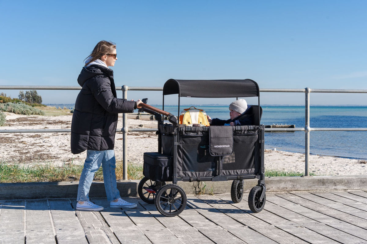 Cody walks beside his WonderFold on a sunny footpath