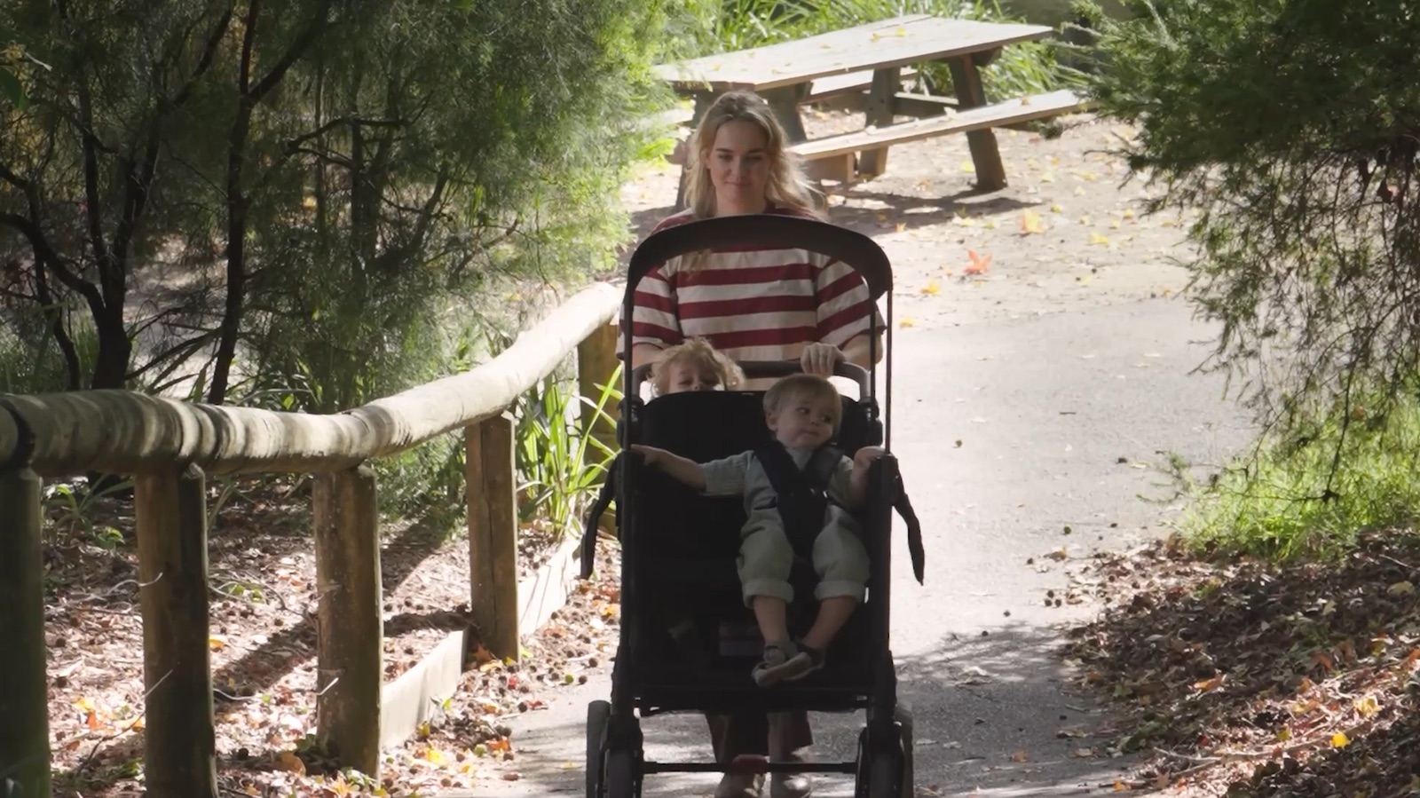 A parent pushes a WonderFold along an Australian bush path