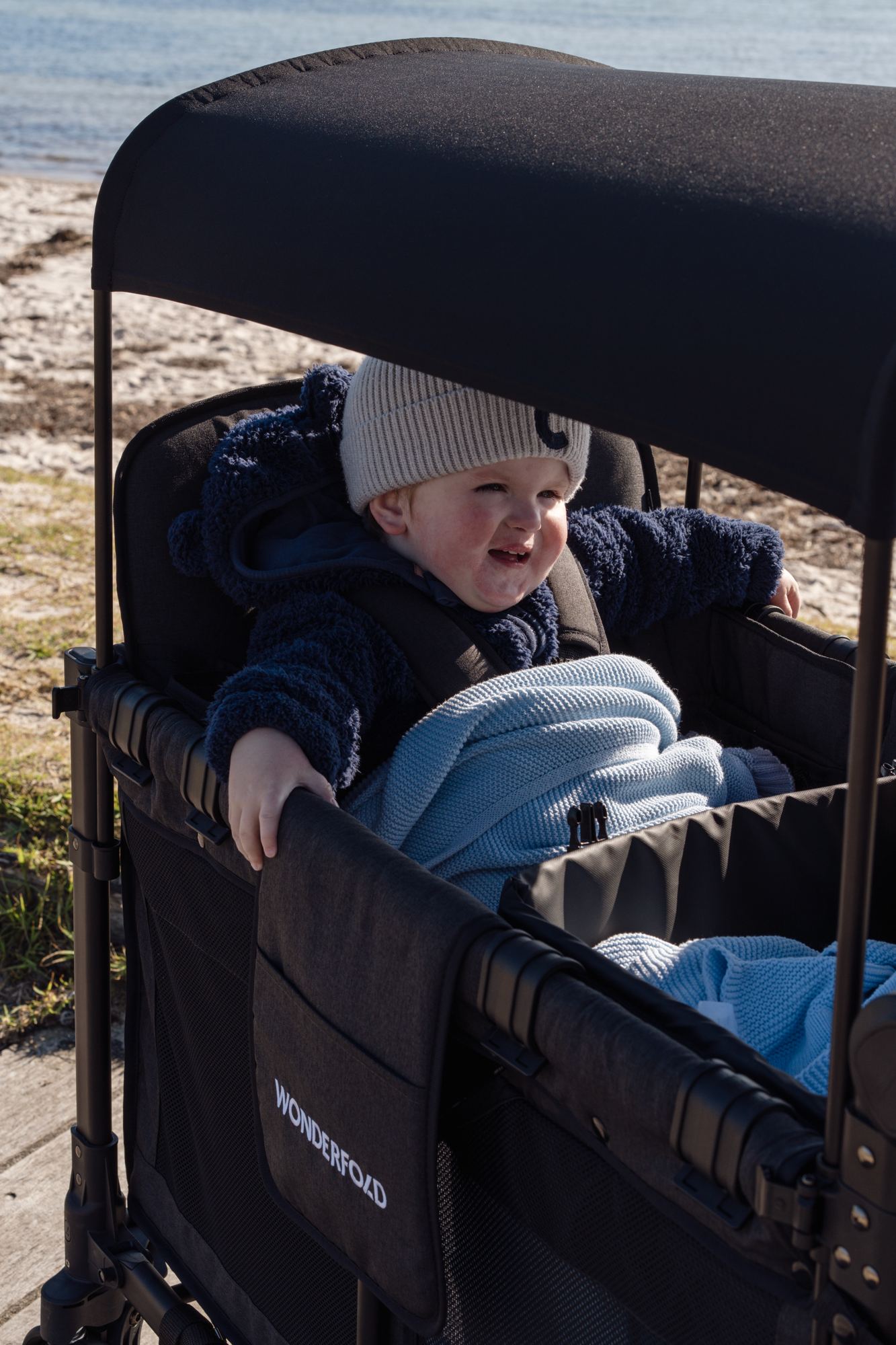 Cody, our WonderFold ambassador, smiling in his W4 at the beach